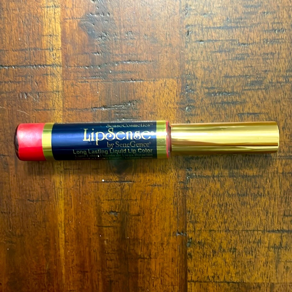 This is a reddish pink lipstick by lipSense unopened still sealed